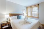Elegant master bedroom with natural wood finishes